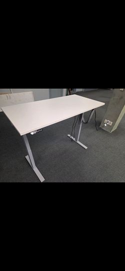 White motorized desk with chair