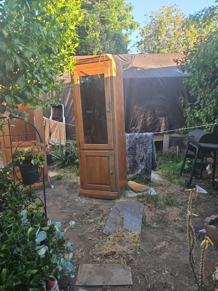 Two Tall Oak Cabinets With Lights And Shelves