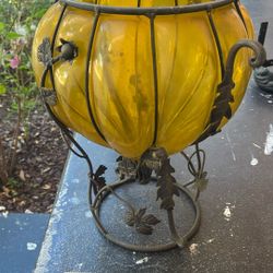 Vintage Mid-Century Modern (MCM) large amber blown glass footed vase or planter in a wrought iron cage