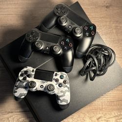 Black PS4 w/ three controllers