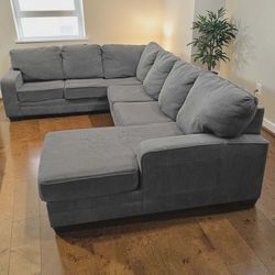 Large grey blue sectional couch with chaise