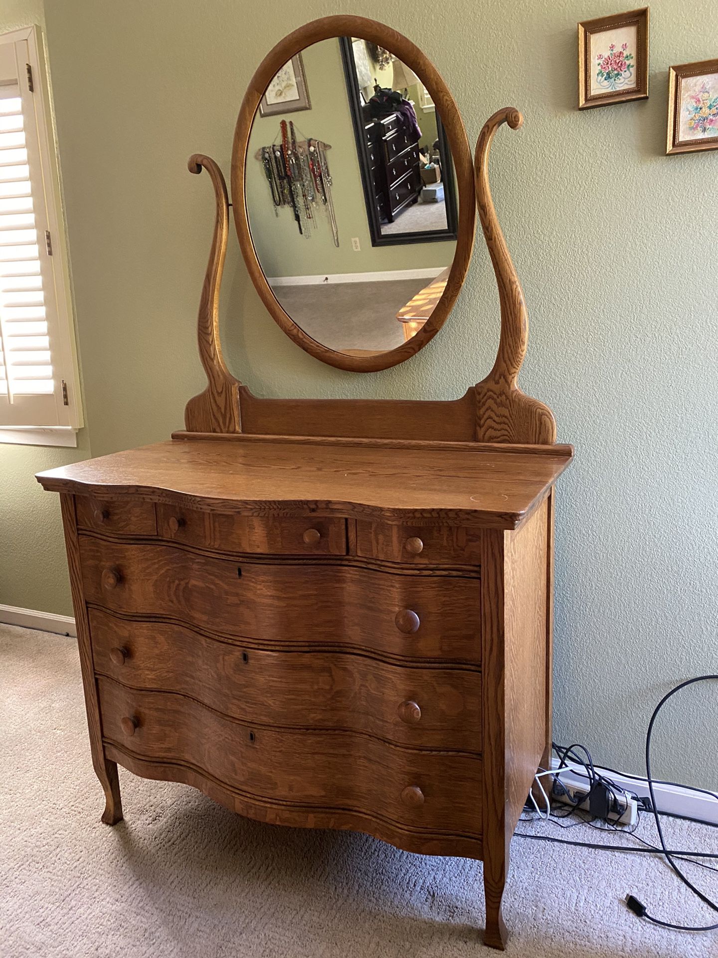 Oak serpentine front dresser with mirror.