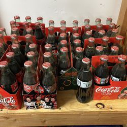 9 Sets Of Coca Cola Bottles 