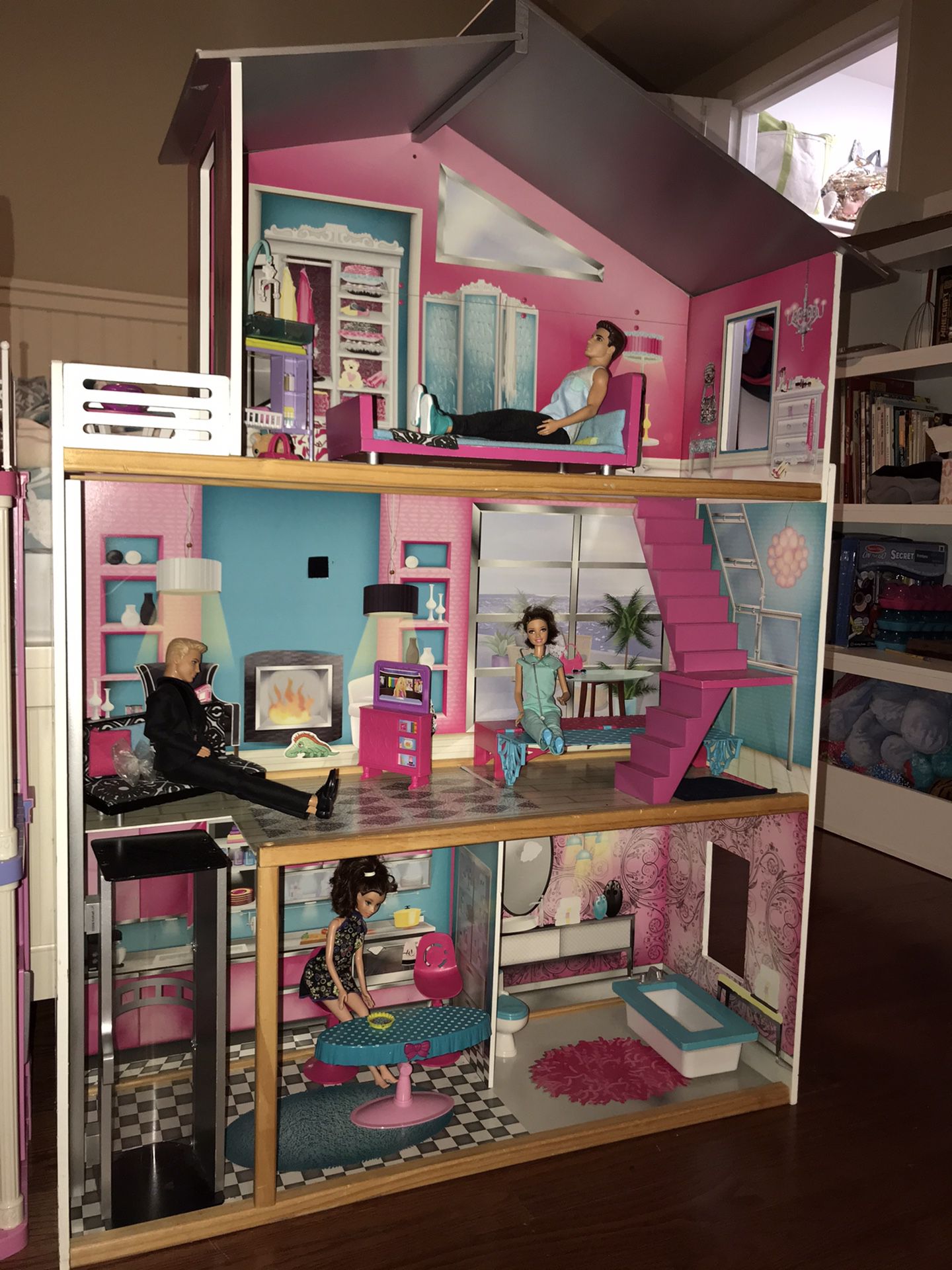 Two Barbie houses with clothes