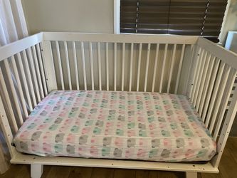 White crib converts into toddler bed