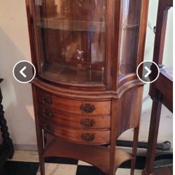 Antique cabinet with curved glass