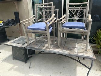 Patio table with 6 chairs, 4 cushions and propane fire pit