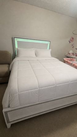 Bedroom set: bed with two nightstands and a dresser with a mirror .