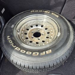Set of 3 trailer rims and 1 tire.