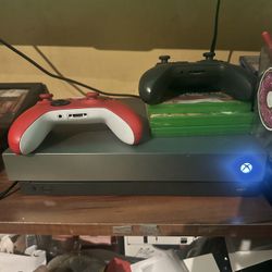 xbox one S grey with two controllers and battery pack to charge batteries 