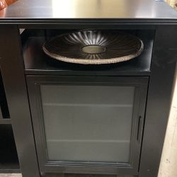 Black cabinet with glass door and three shelves