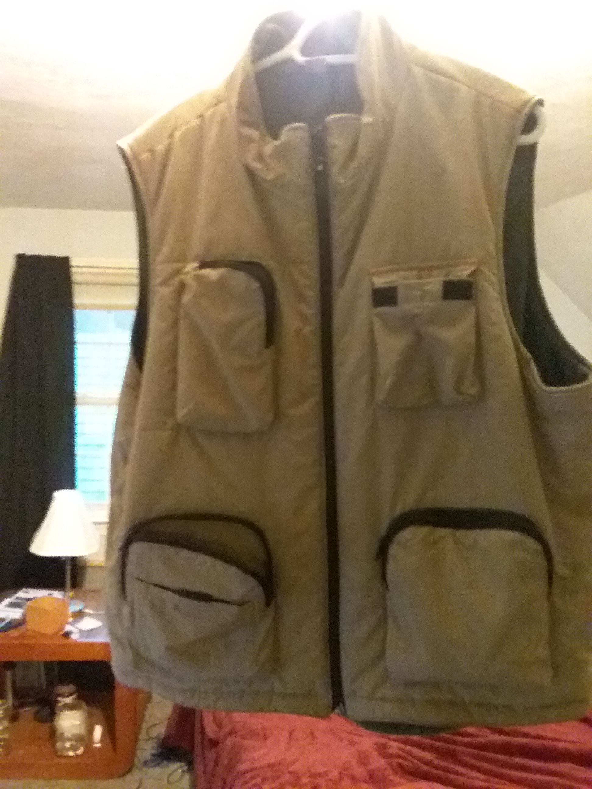 Fishing vest and two fly rod hard cases and waders