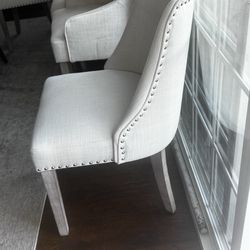 4 cream colored chair with metal stud decor