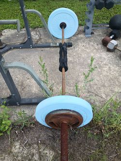 Olympic bar with two 45 lbs bumper plates