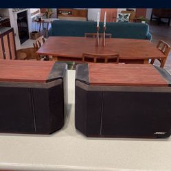 Vintage bose speakers with wall mounting brackets.