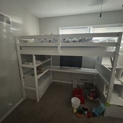 white wooden loft bed with built in desk/dressers
