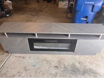 Entertainment center/ Tv stand with fireplace and storage $300 obo