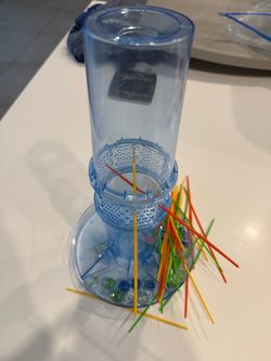 The KerPlunk Marble Drop Game is a fun and engaging children's game suitable for ages 5 and up. With a minimum of 2 players, this complete game featur