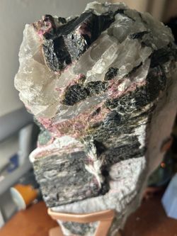 This is his gorgeous tourmaline statement piece is a true natural wonder. On one side, you'll find its raw, intriguing matrix, while the other half sh