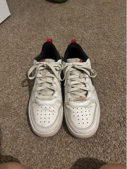 White with sparkly black Nike logo dunks and red bottomed shoes