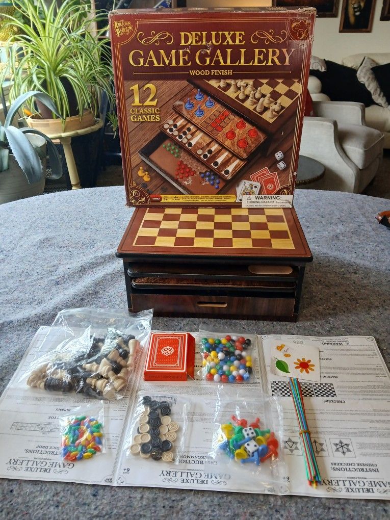The Deluxe Game Gallery Wood Finish includes 12 classic board games perfect for 4 players or more. Made by Anker Play Products, this game board featur