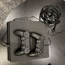 PS4 with two controllers, MW2, and Last of Us Remastered