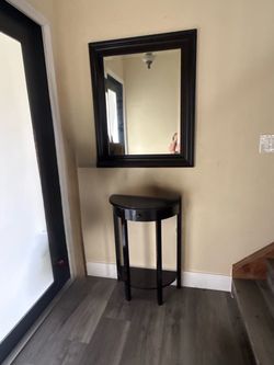 entryway set featuring a mirror and a console table.