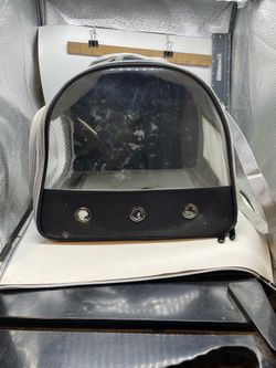 portable black soft-sided pet travel carrier with a clear vinyl front window and adjustable shoulder strap