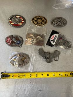 assorted vintage metal belt buckles featuring Western, patriotic, and motorcycle theme