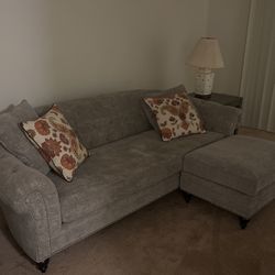 Couch With Extended Leg Chair And Four Decorative Pillows 