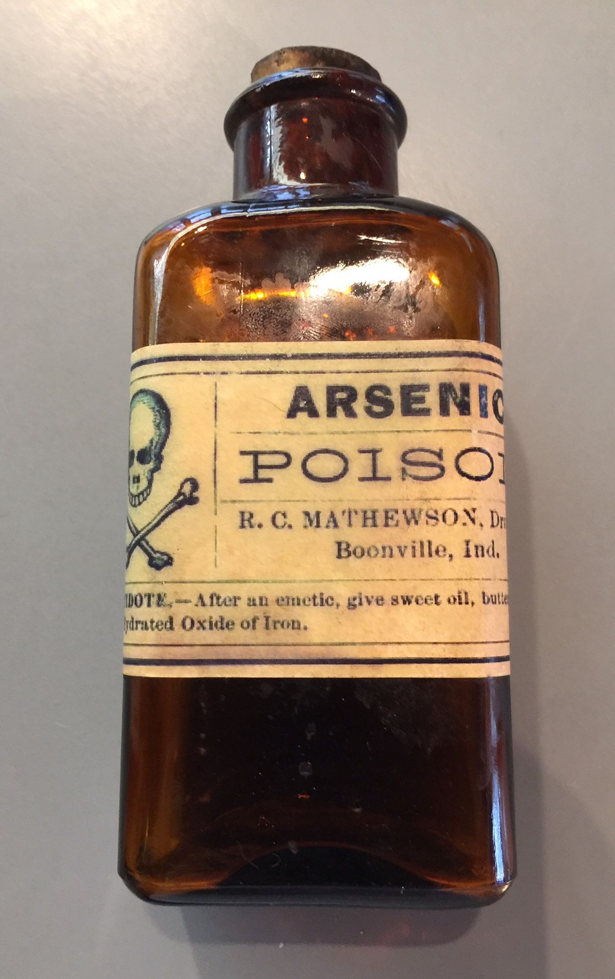 Antique poison bottle with original label, bottle and cork.