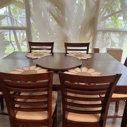 High top dinner table with 6 chairs. Also extends to make larger. Normal wear and tear.