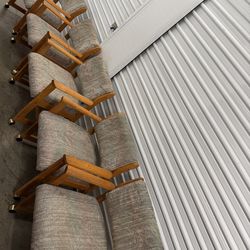 Vintage oak dining armchairs from the 1980s, with casters and textured upholstery.