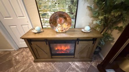 Beautiful rustic fireplace/tv stand with sliding barn doors 60”