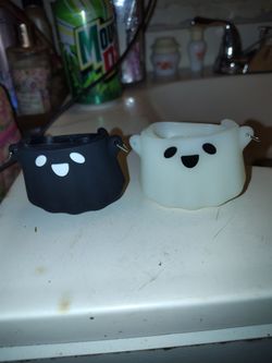BRAND NEW, OPENED NEVER USED BLACK & WHITE GHOST DESIGNED EARBUDS CASES. VERY CUTE!!!