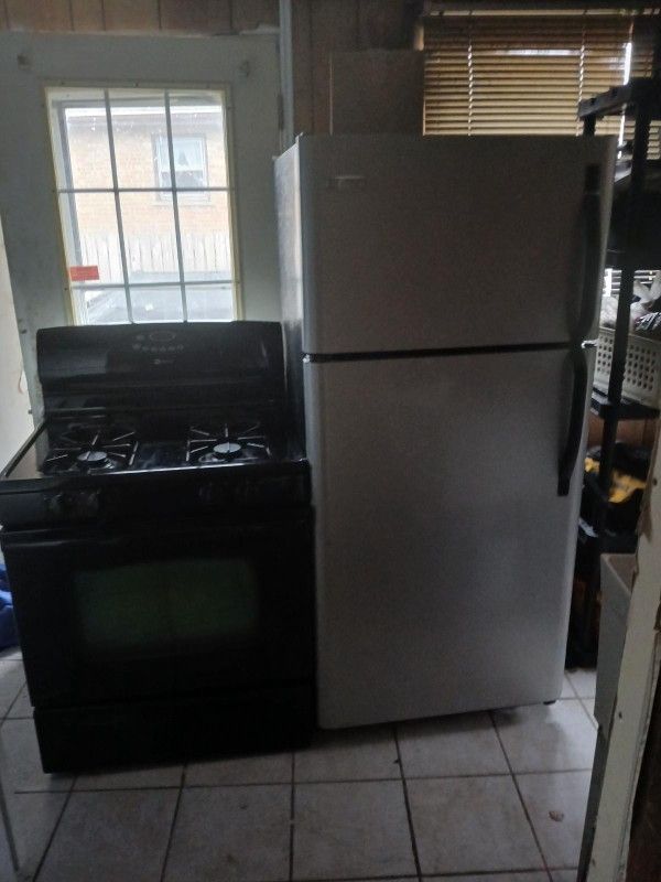 Frigidaire Stainless Steel fridge and black Maytag stove