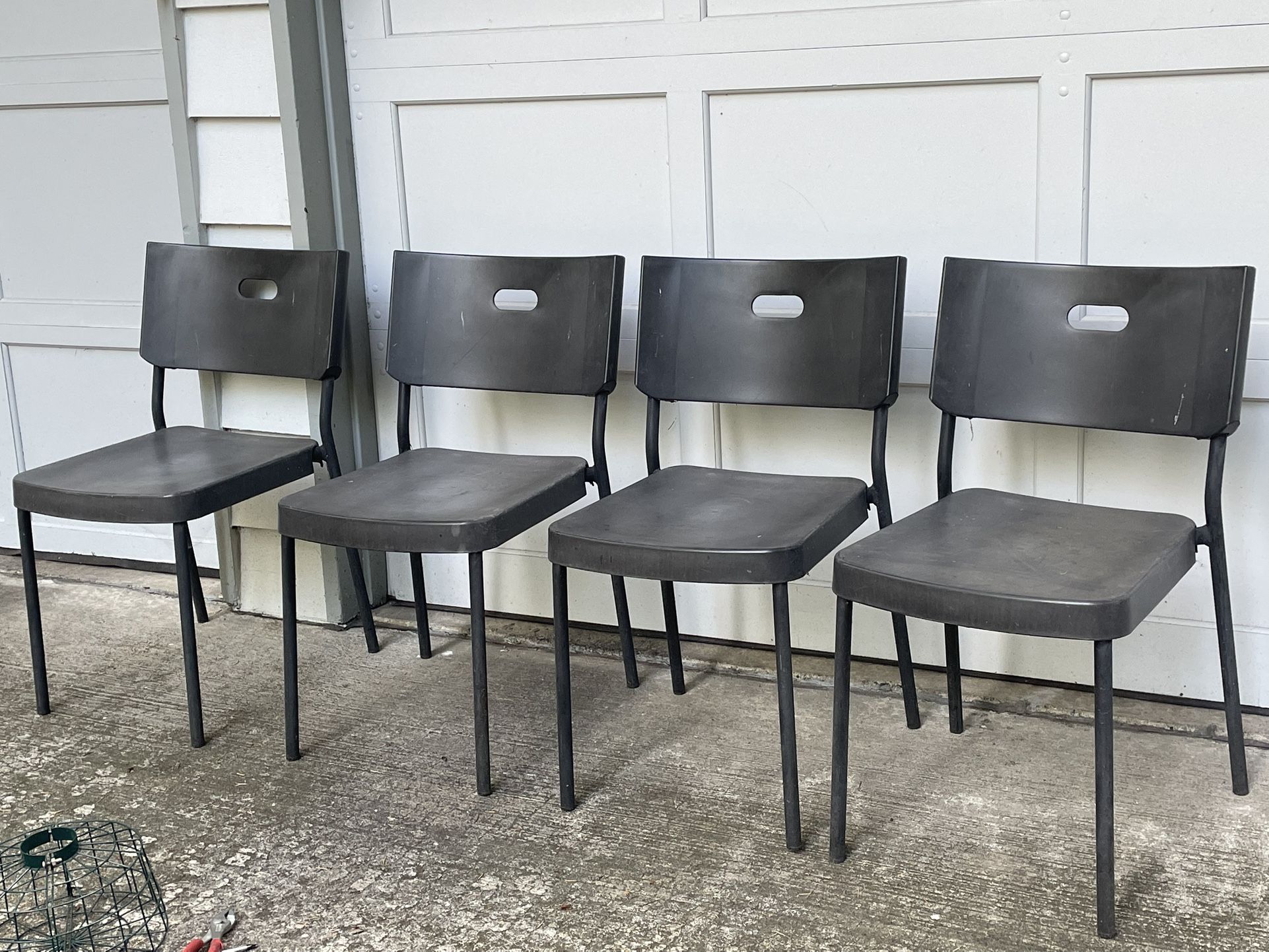 4 Black Stacking Chairs $10