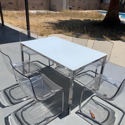 white table with clear chairs 