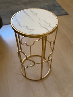 Gold accent table with a marble top
