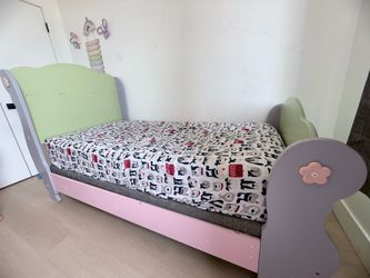 Kids Twin Bed Frame – Good Condition  Cute and sturdy kids twin bed frame in pastel colors (pink, green, and lavender). Perfect for a child’s bedroom.