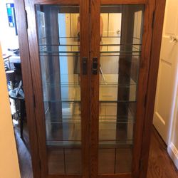 Lead glass beautiful oak lighted cabinet This cabinet is 54” high 32”wide and 15 “ deep very high quality and perfect for a small area