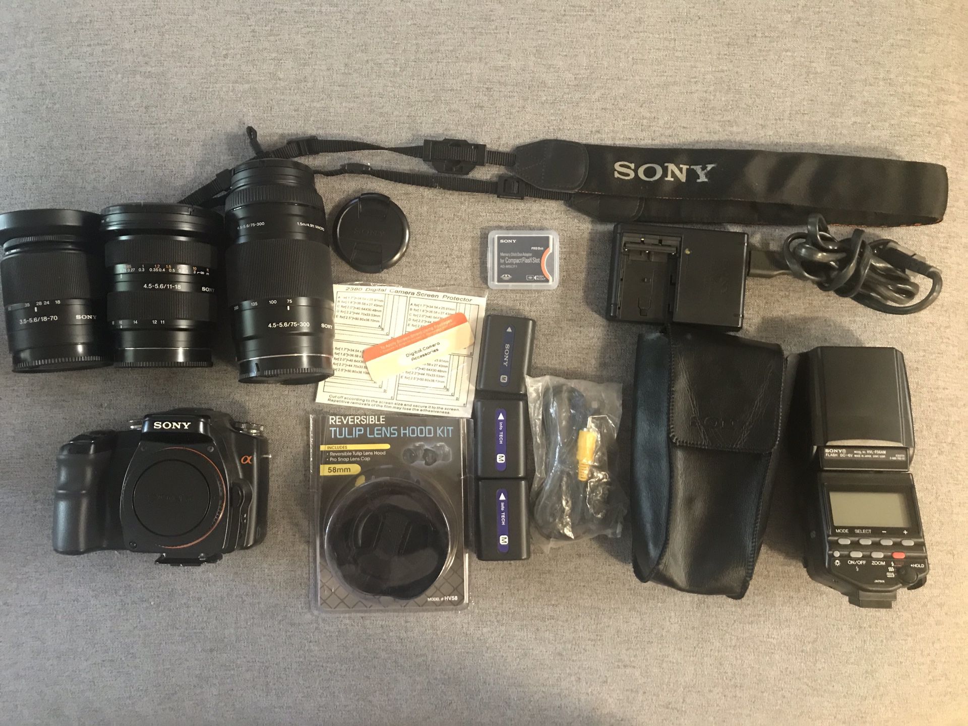 Sony camera, gear, flash, camera backpack, and 3 lens