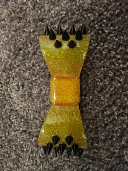 ITEM: YELLOW HELMET BOW WITH BLACK SPIKES $5