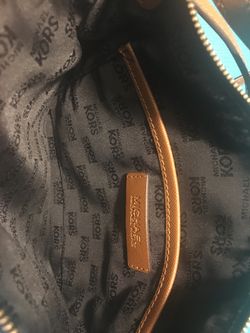 Authentic Michael Kors Purse with matching wallet.
