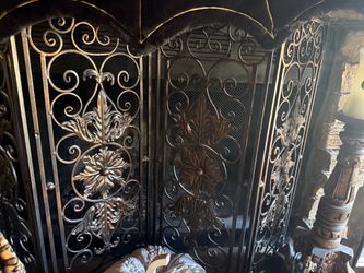 Ornate wrought iron fireplace screen