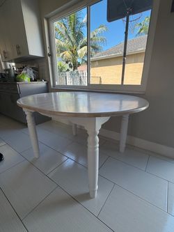 White and wood tone kitchen or dining table with leaf extension