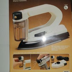 Travel iron with sprayer.