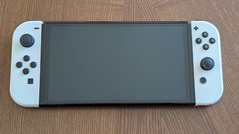 OLED Nintendo Switch w/Four Games & Case