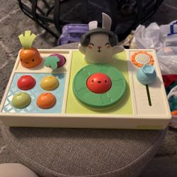 Skip Hop Farmstand Let The Beet Drop DJ Set baby musical toy features a light-up bunny with 5 songs, a carrot and beet seesaw, and tomato buttons that