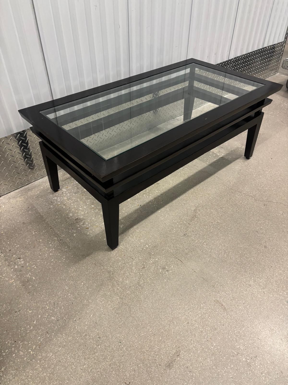 Dark brown, solid wood glass, top coffee table….45” wide , 24” depth , 18 “ high $60